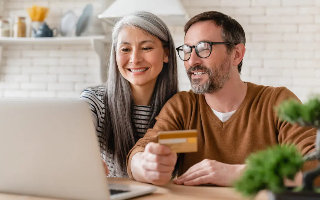 A couple looking at their credit on laptop.