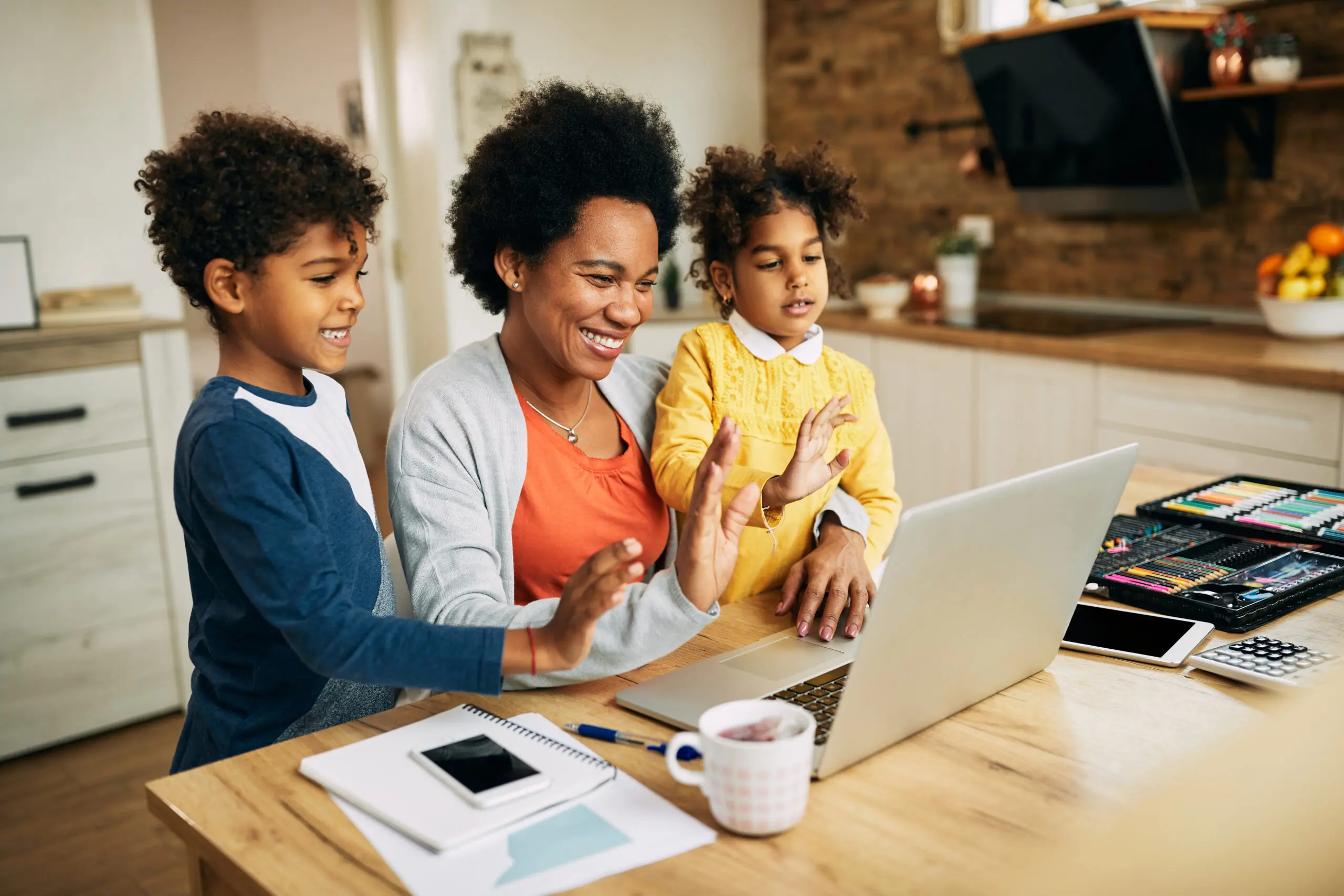 Family sitting together at kitchen table.