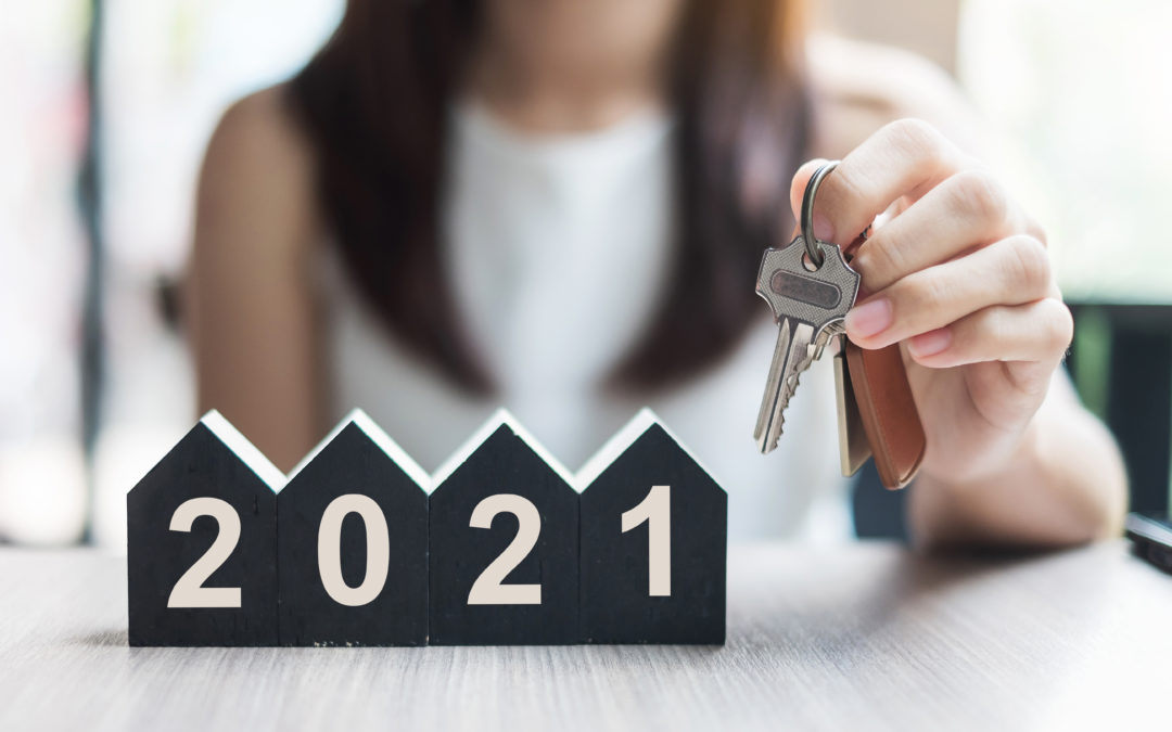 Woman holding keys in front of 2021 sign