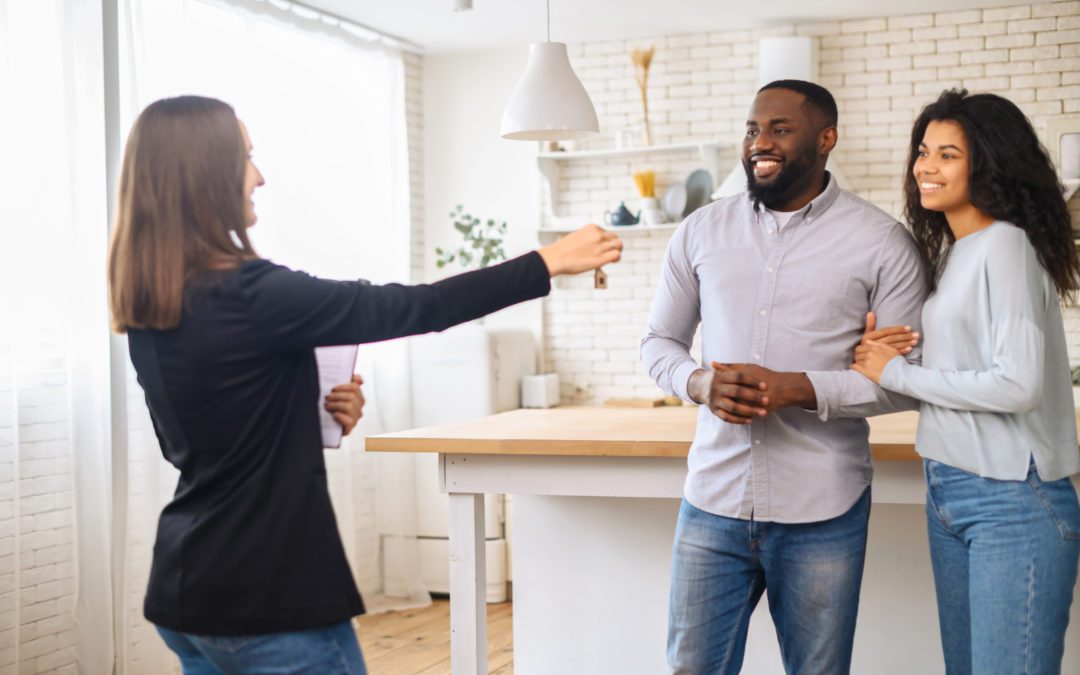 Young Couple Receiving Keys to Home