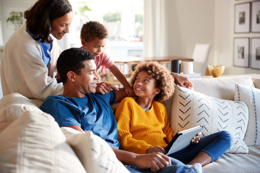 Family sitting together on couch.