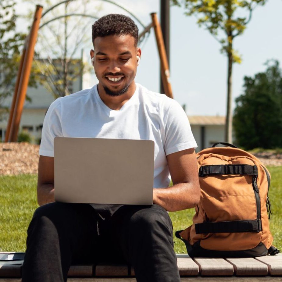 Man sitting on bench outside.